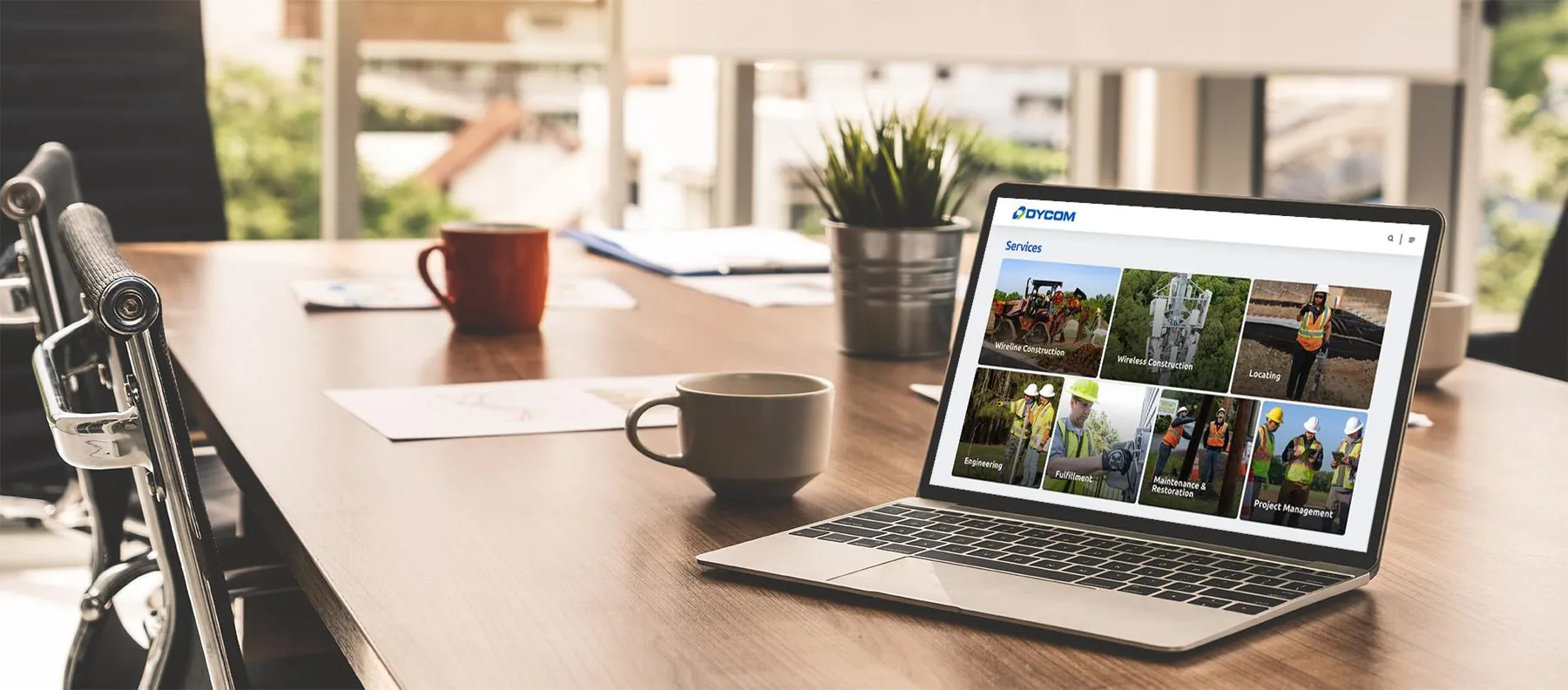 Redesigned Dycom Services page on a laptop, showing a photo grid of service lines including wireline construction, wireless construction, locating, engineering, and project management